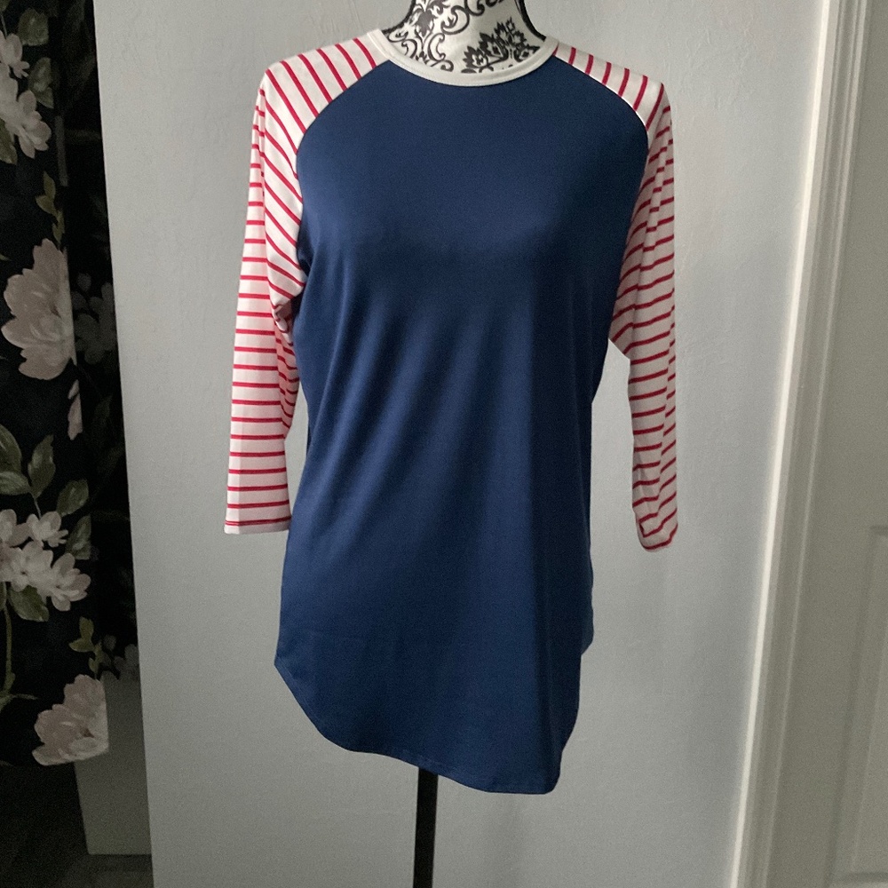 Navy shirt with quarter cut red and white stripped sleeves.